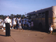 Children board a bus at Retta Dixon